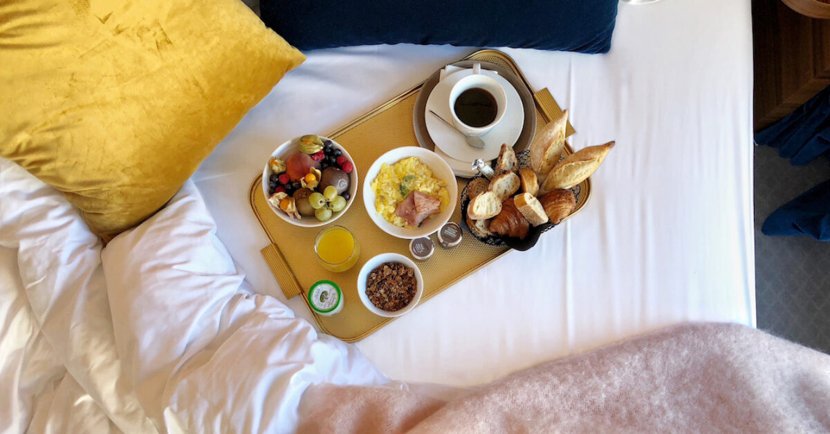 A tray of food on a bed