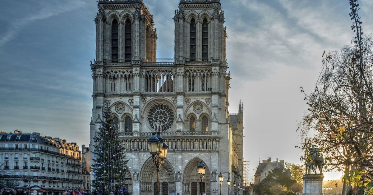 A large clock tower in front of Notre Dame de Paris