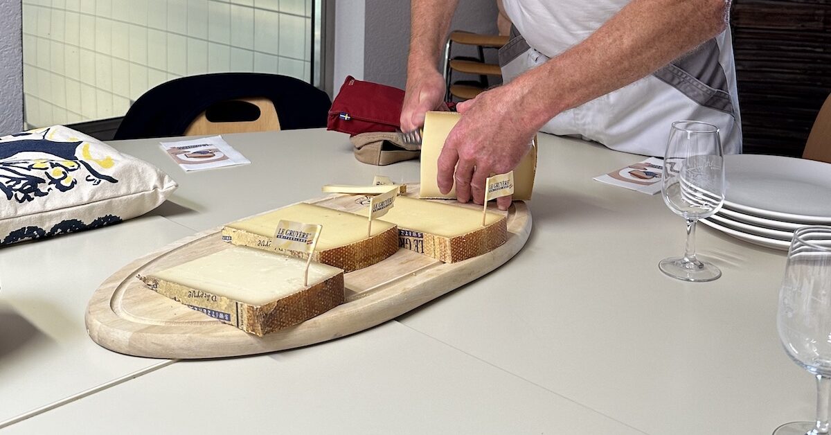 Wooden board with various cheeses on it