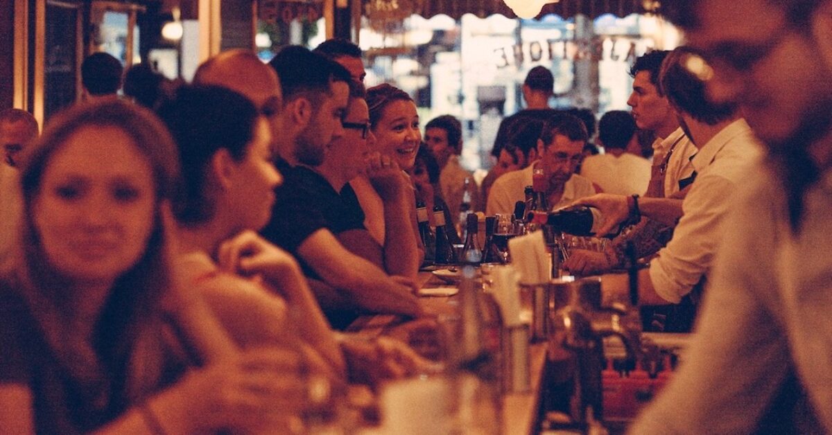 A group of people sitting at a table in a restaurant