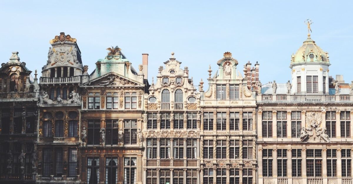 A bunch of furniture in front of a large building with Grand Place in the background