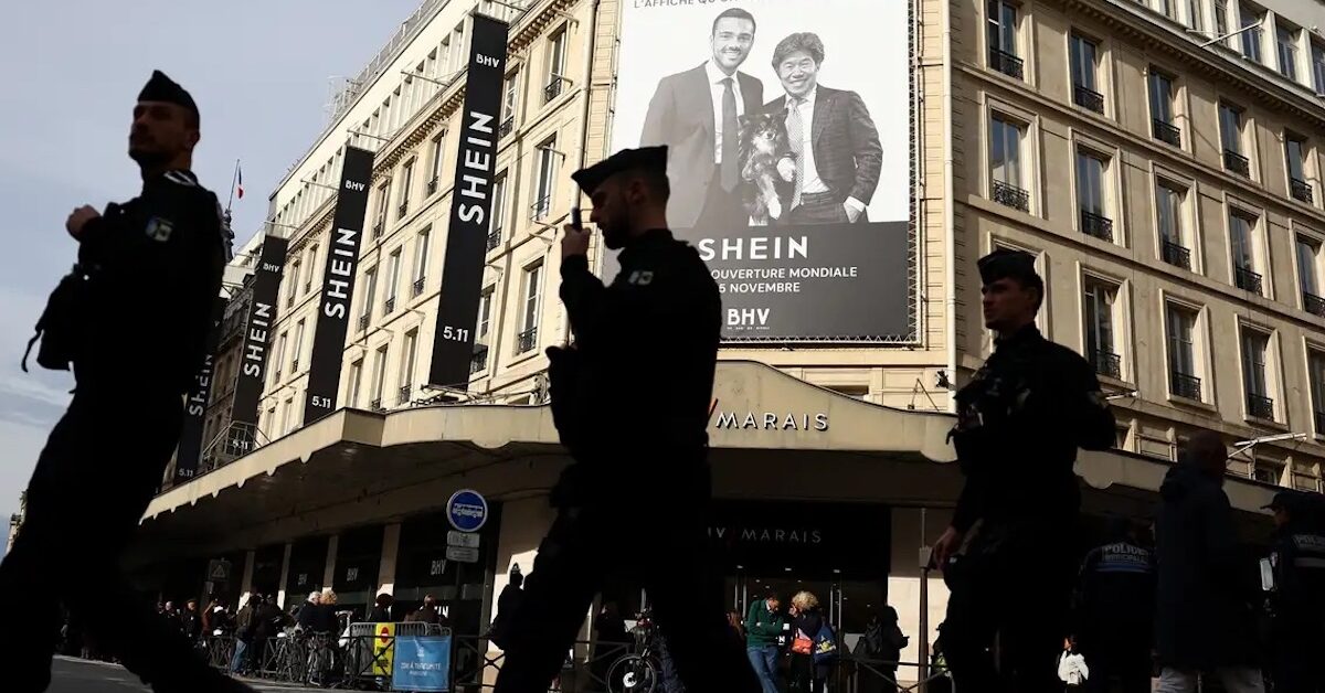 French police walking in front of SHEIN's BHV flagship store.