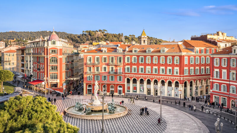 Aerial view of Place Massena square with red buildings and fountain in Nice, France