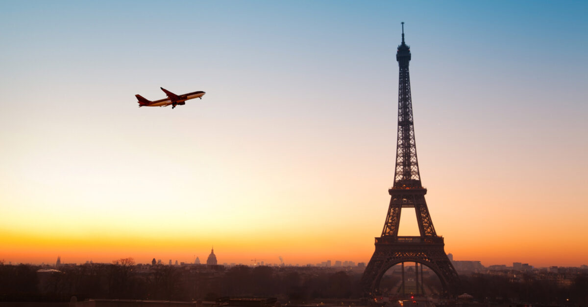 Airplane flying in the sky by the Eiffel Tower in Paris