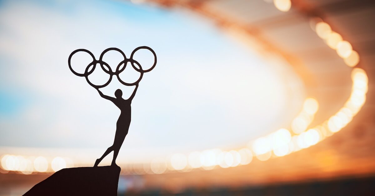PARIS, FRANCE, JULY 7, 2023: Iconic Gesture: Statue of Athletics Woman Triumphantly Lifts Olympic Circle at Modern Olympic Stadium.