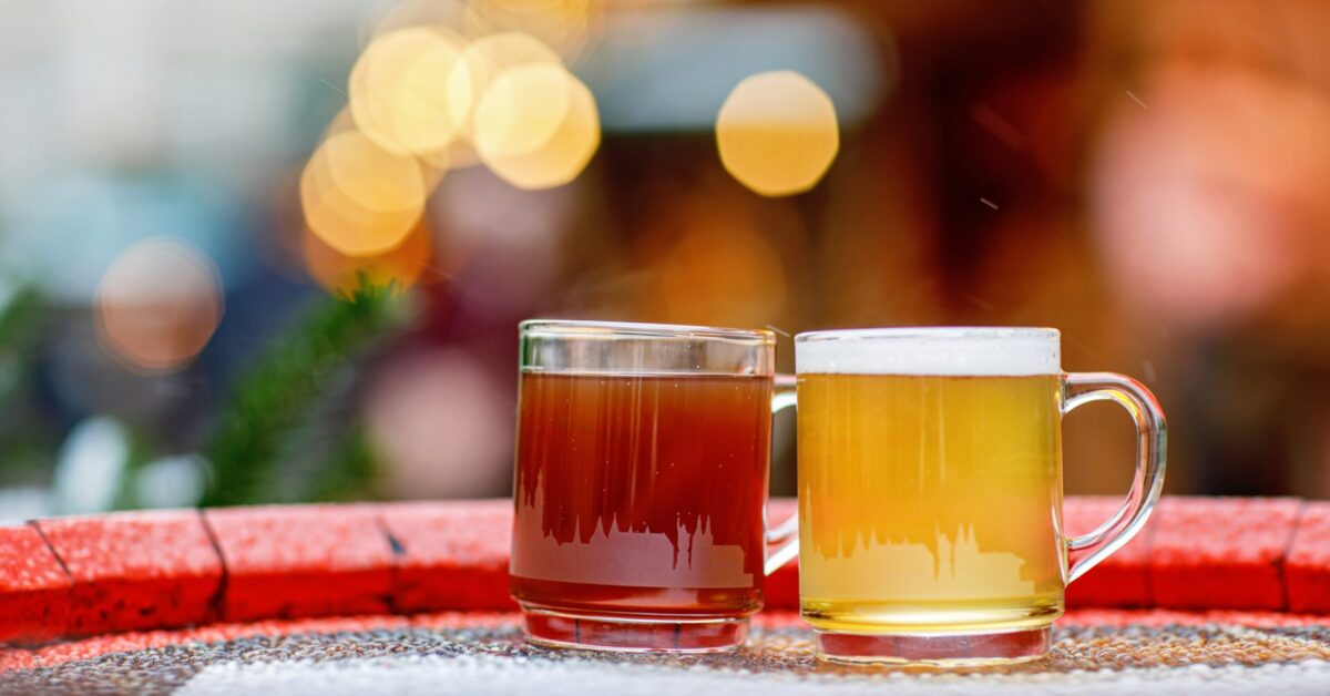 Two,Glasses,Mugs,With,Red,And,White,Mulled,Wine,On