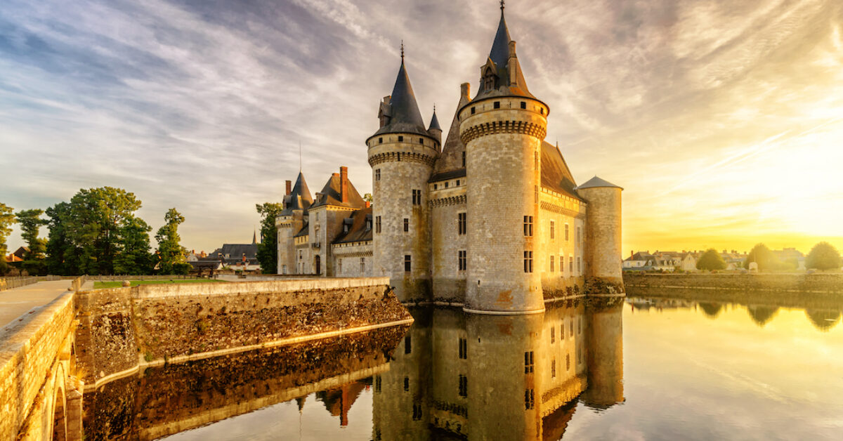 Castle Sully-sur-Loire at sunset, Loire Valley, France, Europe. Nice view of medieval castle (French chateau) in sun light. Beautiful sunny scenery of Loire Valley landmark with reflection in water.