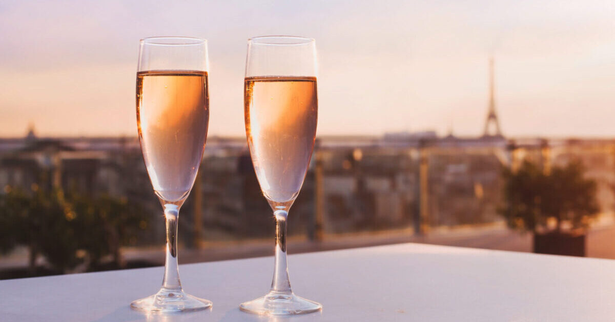 Two,Glasses,Of,Champagne,At,Rooftop,Restaurant,With,View,Of