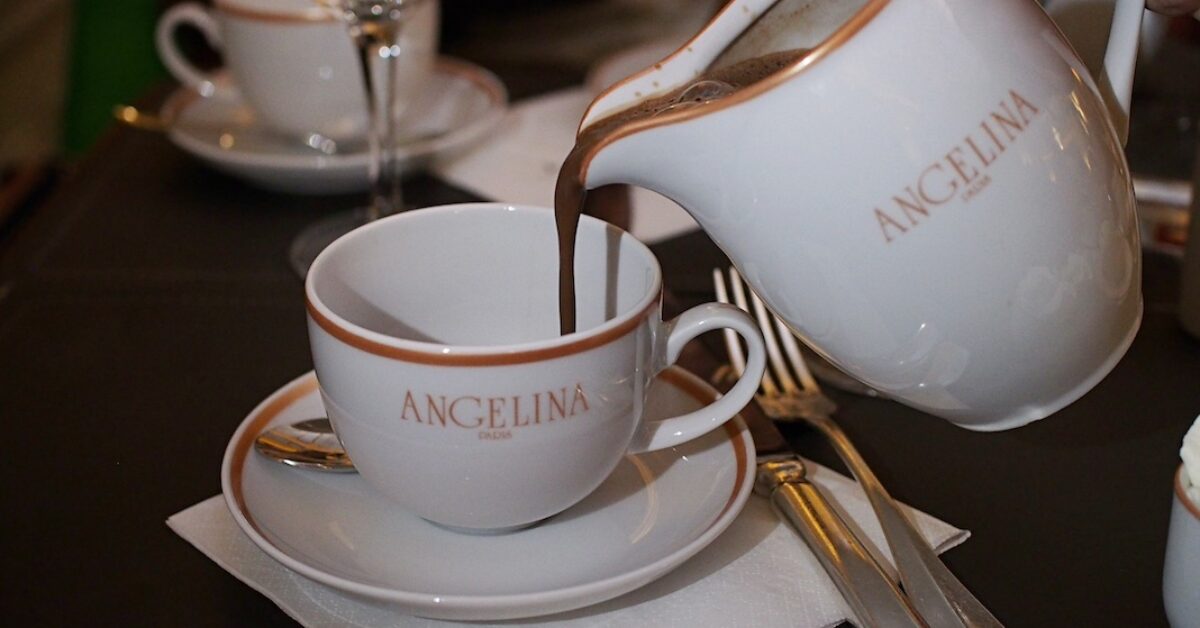 Angelina branded pitcher of hot chocolate being poured into tea cup
