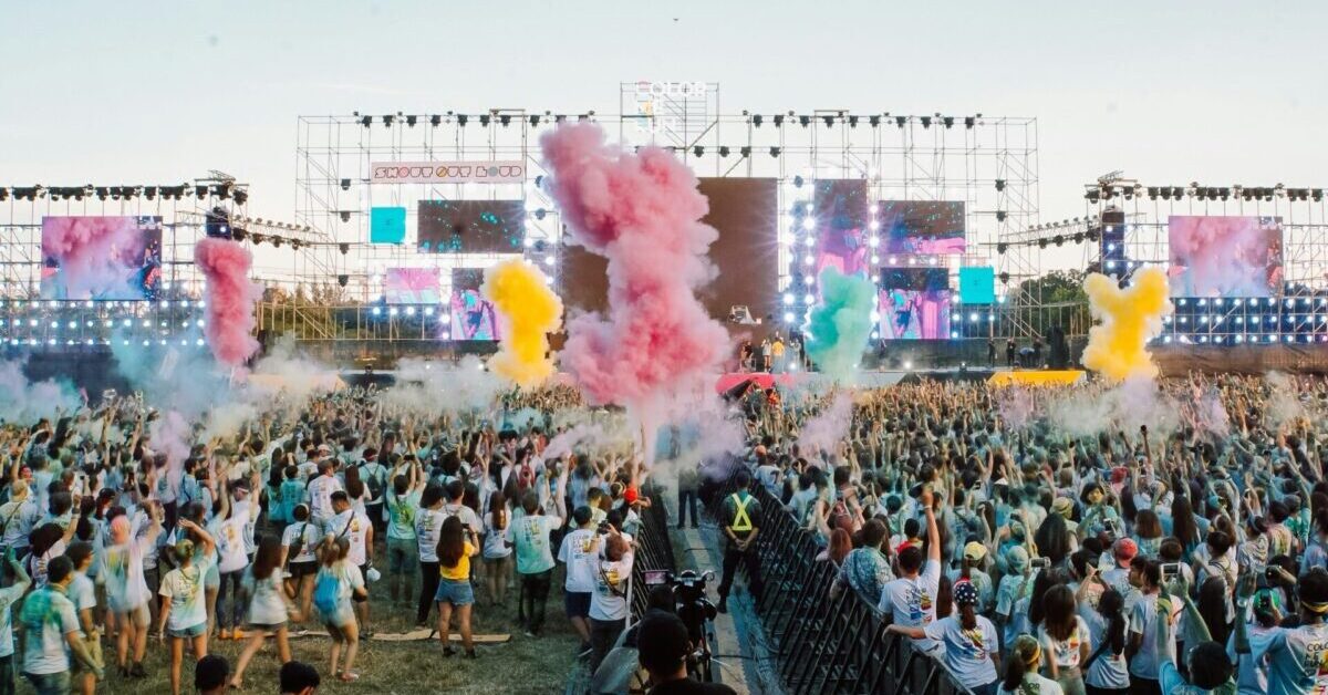 A crowd in front of a music festival stage.