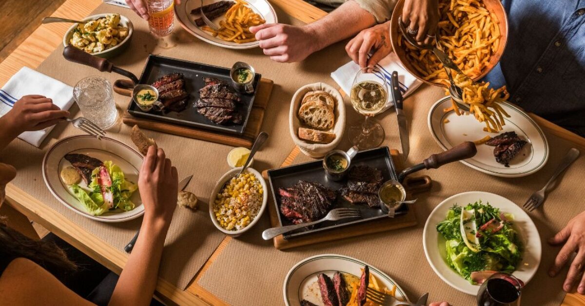 People enjoying steak and fries, aerial view