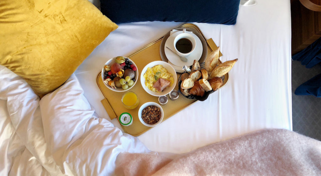 A tray of food on a bed