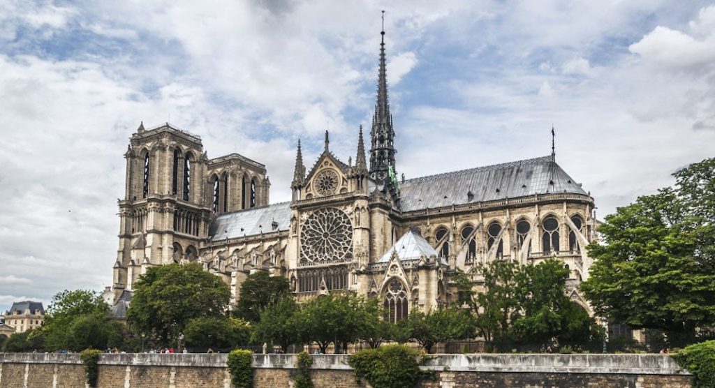 A large stone building with Notre Dame de Paris in the background