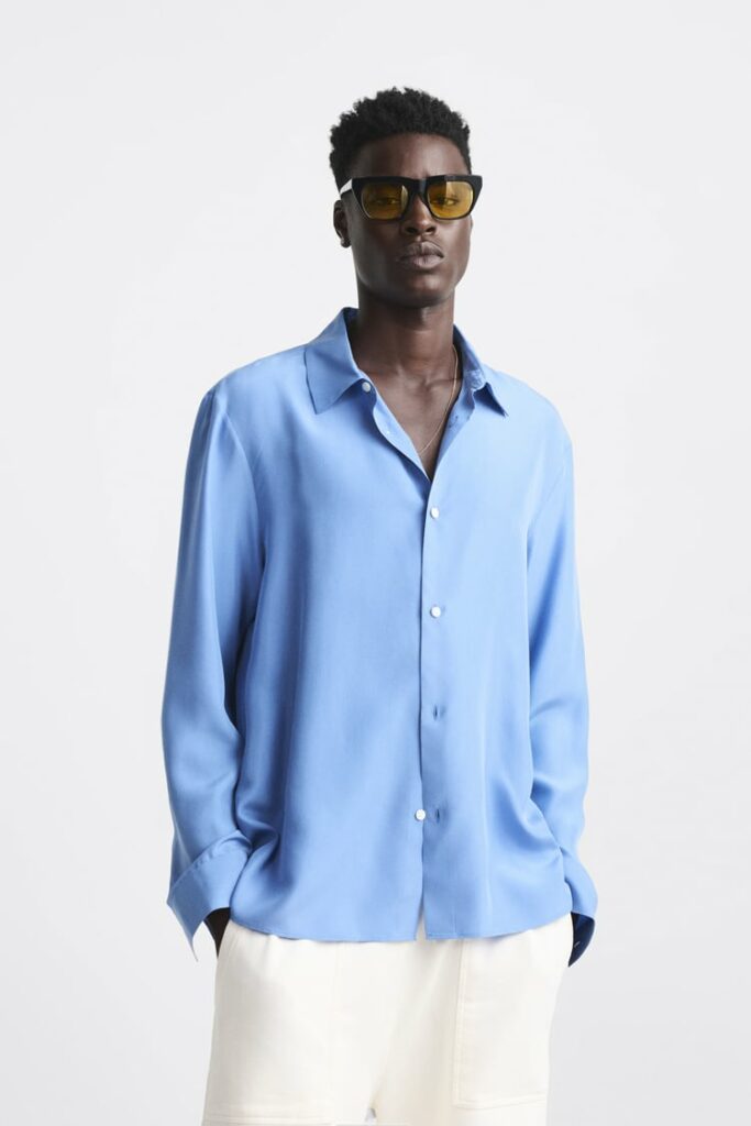 a man wearing a blue silk shirt