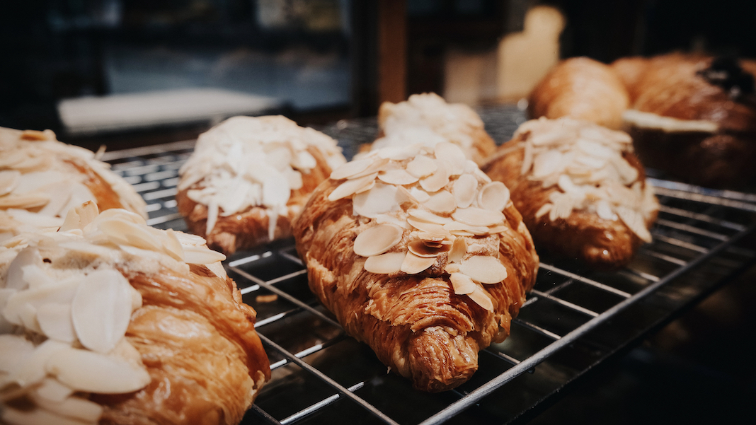 Delicious almond croissants on metal grate