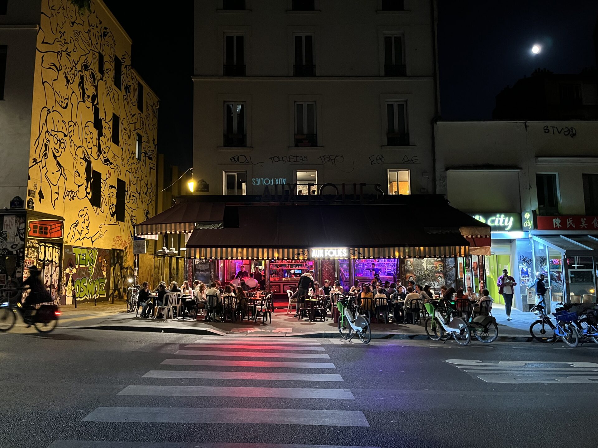 Exterior of Paris bar with crowded terrace