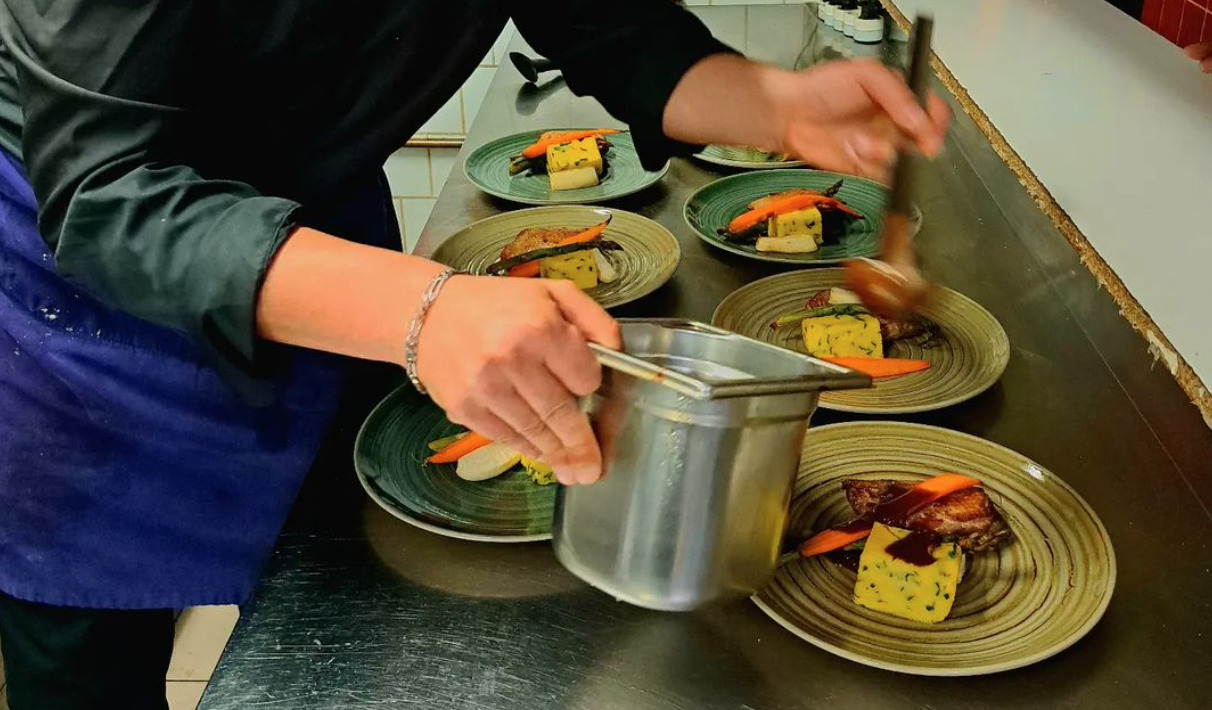 A chef preparing dishes at La Brasserie des Chartrons
