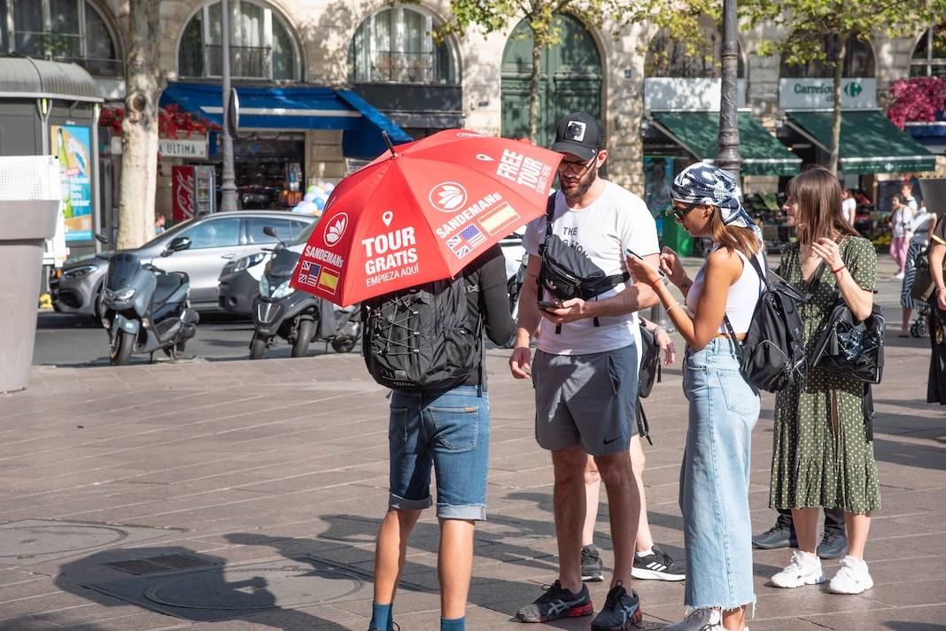 Paris, France. August 2022. A guide tells his story to tourists in Paris. High quality photo