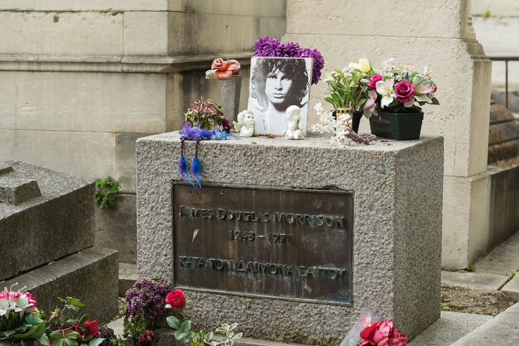 PARIS, FRANCE - APRIL 29, 2016: Jim Morrison's grave in the Pere Lachaise Cemetery. He was an American singer, songwriter, and poet best remembered as the lead singer of The Doors.